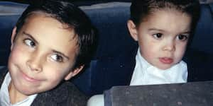 Jona sitting next to his brother smiling.