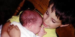 Jona holding his brother when he was born.