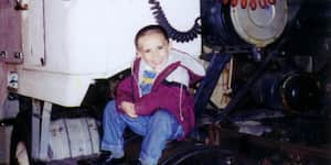 Jona sitting on the back of a semi truck.