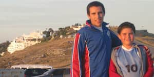 Jona and his brother standing in front of a car.