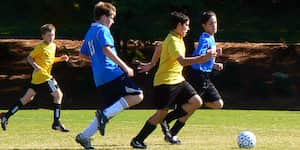 Jona dribbles the ball during a soccer game.