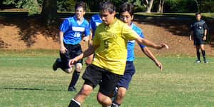 Jona dribbles the ball during a soccer game.