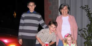 Jona, his brother, and their cousin with their grandmother.